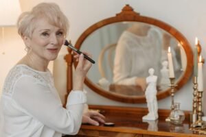 mature woman putting on makeup