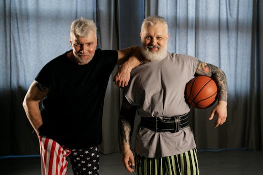 Two senior men enjoying a fun indoor basketball session, promoting healthy living.