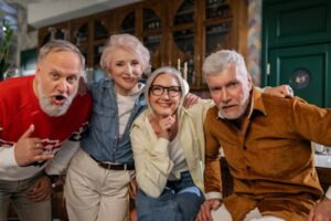 Happy senior adults enjoying a lively and fun gathering indoors at a cozy cafe.