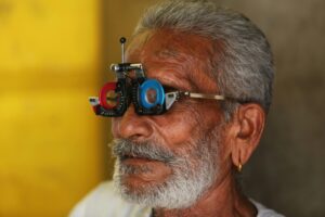 Close-up of a senior man's facial features during an eye examination using specialized equipment.
