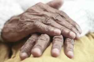 Close-up image of senior adult hands resting, showcasing texture and character.