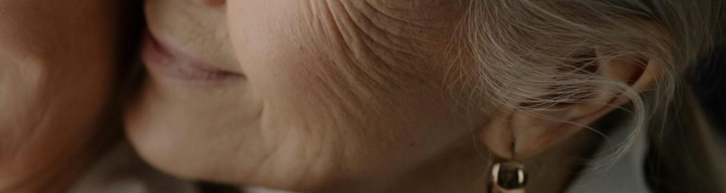pexels-photo-6923495-6923495 Heartwarming close-up photo of a smiling elderly woman showing affection.