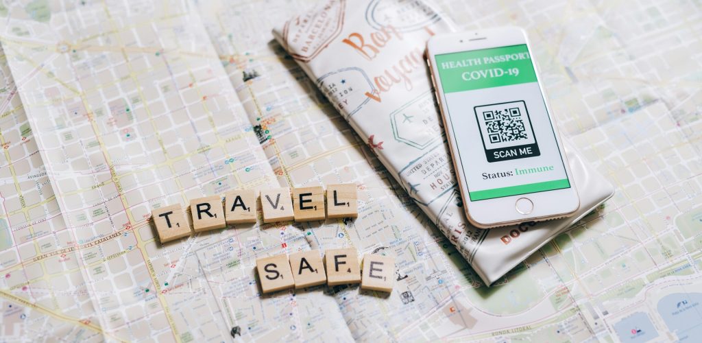 Travel safely with a health passport app displayed on a smartphone over a map.